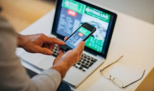 One senior man watches soccer match and bets on the game.